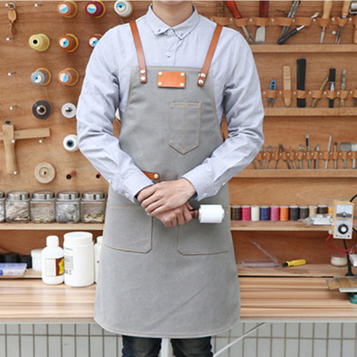 Tablier en toile bleu gris avec bretelles croisées en cuir